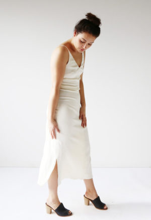 Front/side view of straight size model wearing Cream Myrtle Dress.