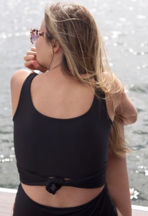 Back view of straight size model wearing Black Scoop Wrap Top.