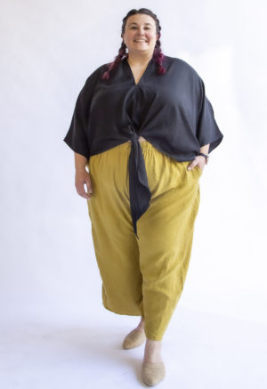 Front view of plus sized model wearing Bow Top in Black Lyocell.