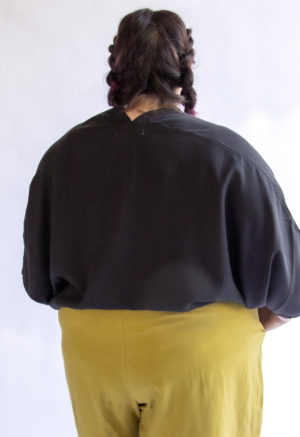 Back view of plus sized model wearing Bow Top in Black Lyocell.