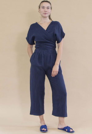 woman in navy short sleeve wrap top and matching navy wide-leg pants