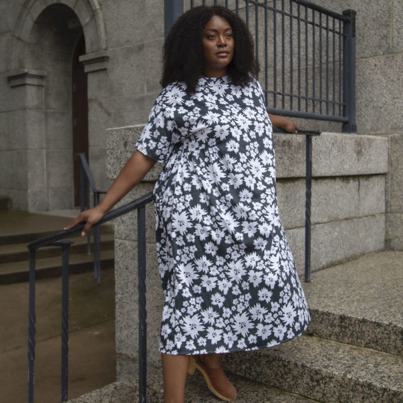 Front view of plus size model wearing Gathered Midi Dress in Jungle Green Floral.