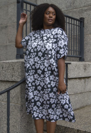 Front view of plus size model wearing Gathered Midi Dress in Jungle Green Floral.