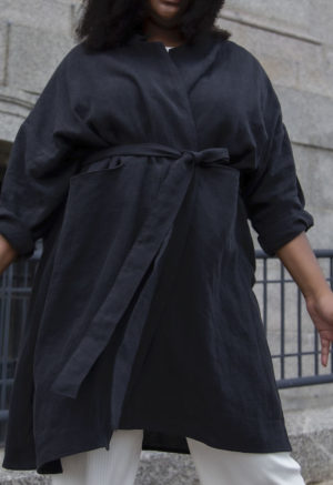 Front view of plus size model wearing Lapel Midi Jacket in Black Linen.