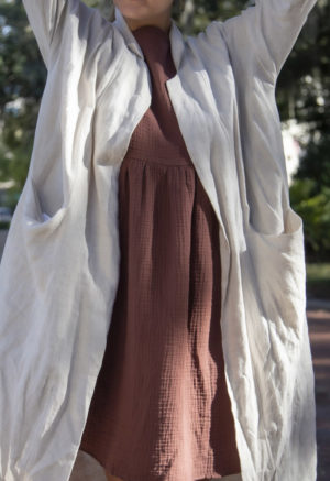 Close up front view of straight size model wearing Lapel Midi Jacket in Oatmeal Linen.