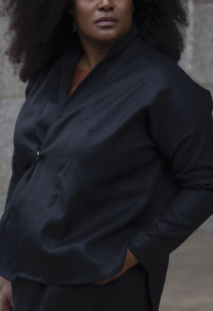 Closeup view of plus size model wearing the Modernist Jacket Top in Black Hemp buttoned.