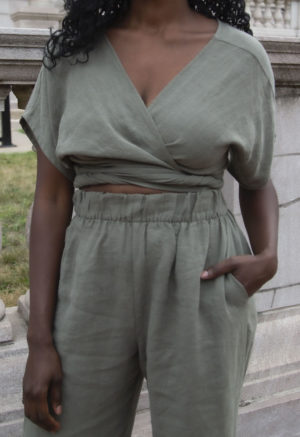 Front view of straight size model wearing Short Sleeve Tie Top in Moss Linen.
