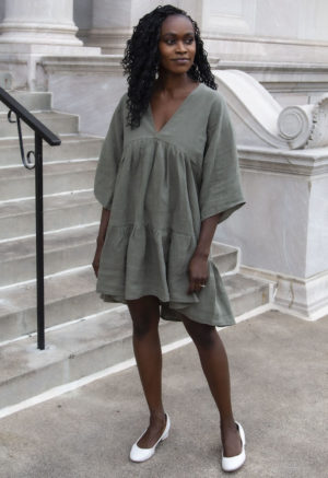 Front view of straight size model wearing Short Tiered Dress in Moss Linen.