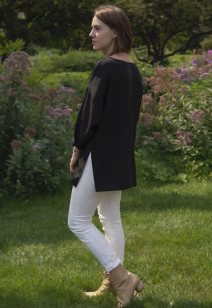 Side view of straight size model wearing Tunic Pullover in Black Lyocell.
