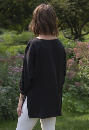 Back view of straight size model wearing Tunic Pullover in Black Lyocell.