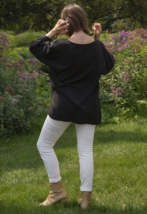 Rear view of straight size model wearing Tunic Pullover in Black Lyocell.