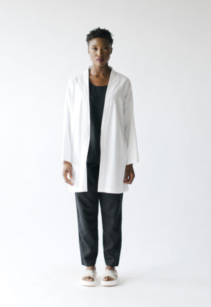 Front view of straight sized model wearing Sustain White Jacket.