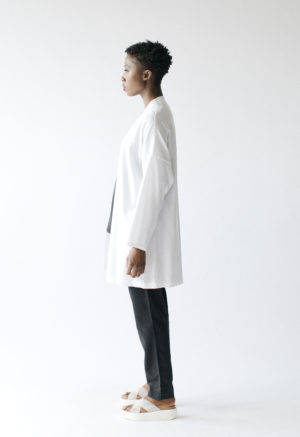 Side view of straight size model wearing Sustain White Jacket.