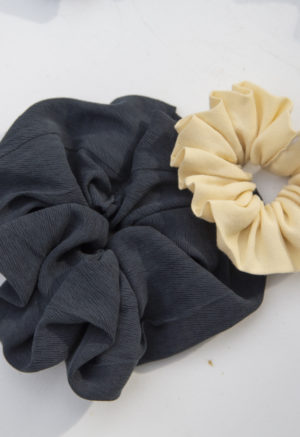 Product shot of Large Scrunchie in Liquorice Lyocell and Small Scrunchie in Italian Straw.