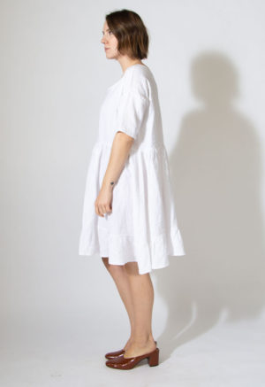Side view of straight size model wearing sample 529 in white cotton.
