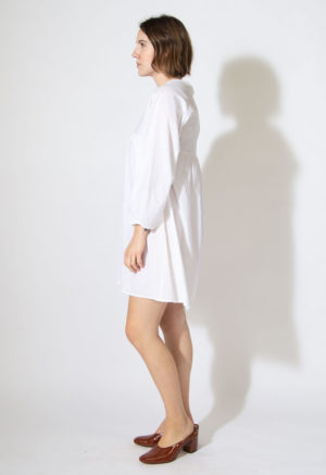 Side view of straight size model wearing Sample 523 in white cotton.