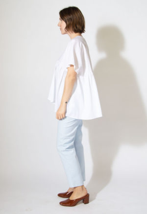 Side view of straight size model wearing Sample 519 in white cotton.