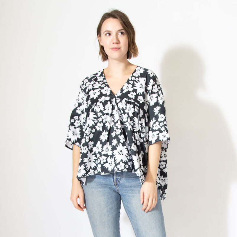 Front view of straight size model wearing v-neck ruffle top in Jungle Floral.
