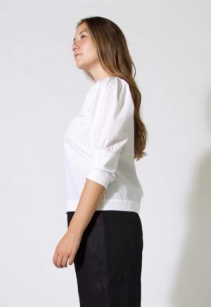 Side view of straight size model wearing sample 508 in white cotton.