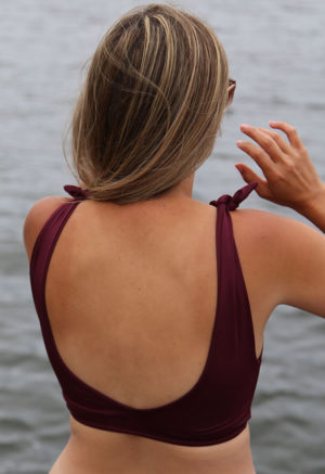 Back view of straight size model wearing shoulder tie top in fig.