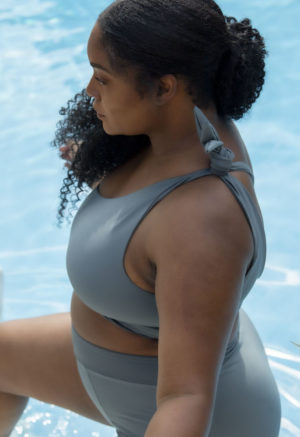 Side view of plus size model wearing One Shoulder Tie Top in Storm.