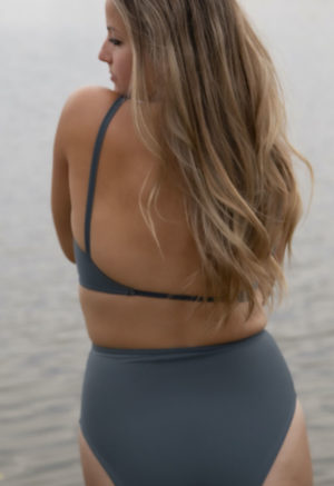 Back view of straight size model wearing Skinny Knot Top in Storm.