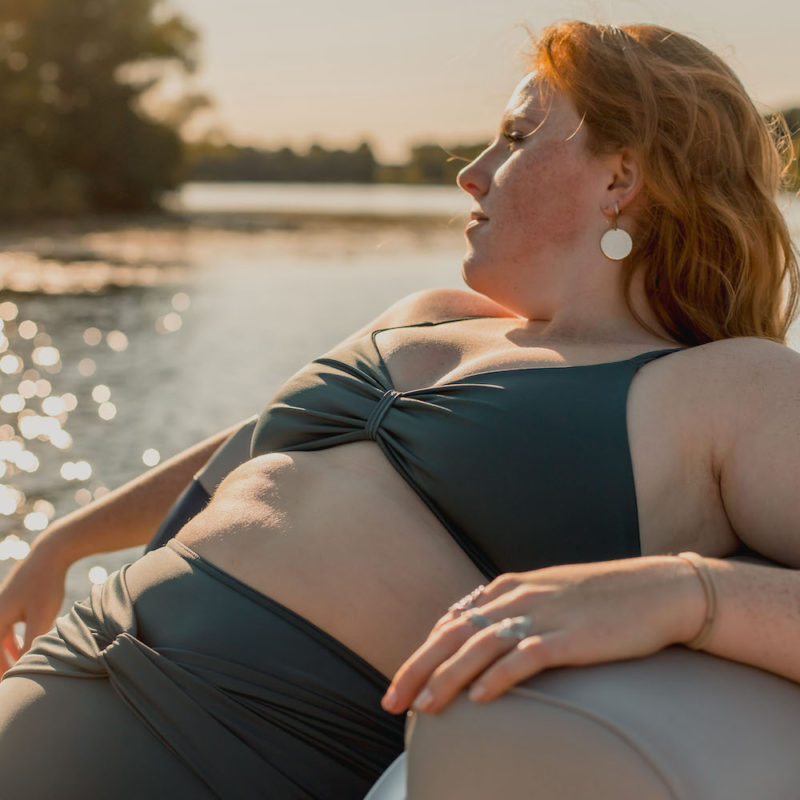 Front view of plus size model wearing Skinny Knot Top in Storm.