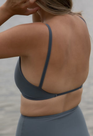 Back view of straight size model wearing Skinny Knot Top in Storm.