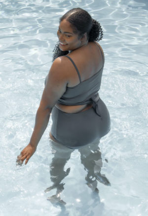Back view of plus size model wearing wrap top in Storm.