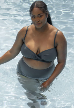 Front view of plus size model wearing wrap top in Storm.