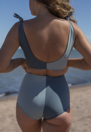 Back view of straight size model wearing Two Tone High Waisted Bikini Bottoms in Eucalyptus and Storm.