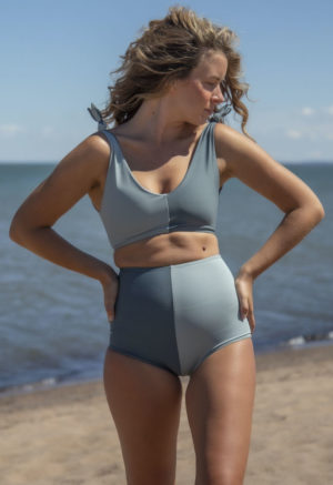 Front view of straight size model wearing Two Tone High Waisted Bikini Bottoms in Eucalyptus and Storm.