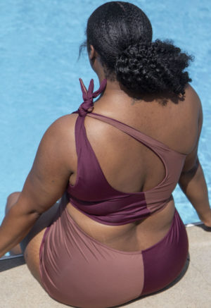 Back view of plus size model wearing Two Tone One Shoulder Tie Top in Chestnut and Fig.