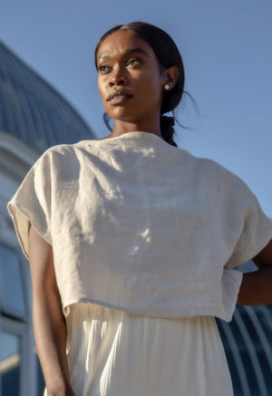 Front view of straight size model wearing Boatneck Crop Top in Oatmeal Linen.