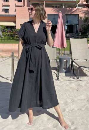 Front view of straight size model wearing Double V Swing Dress in Black Linen.