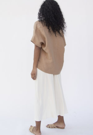 Back view of straight size model wearing Double V Top in Latte Linen.