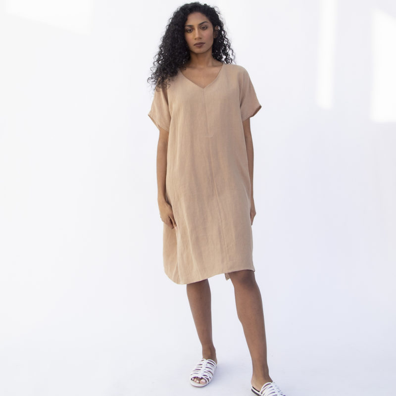 Front view of straight size model wearing Reversible Smock Dress in Latte Linen.