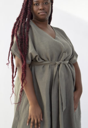 Front view of plus size model wearing Reversible Smock Dress in Moss Linen.