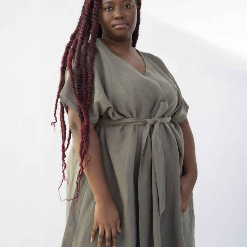 Front view of plus size model wearing Reversible Smock Dress in Moss Linen.