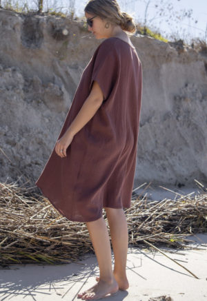 Back view of straight size model wearing Reversible Smock Dress in Raisin Cotton.
