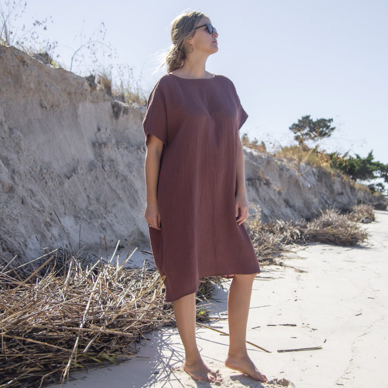 Front view of straight size model wearing Reversible Smock Dress in Raisin Cotton.