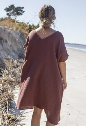 Back view of straight size model wearing Reversible Smock Dress in Raisin Cotton.