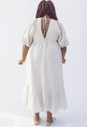 Back view of plus size model wearing Ruffle Midi Dress in Oatmeal Linen.