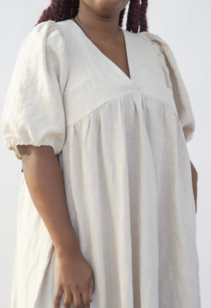 Close up front view of plus size model wearing Ruffle Midi Dress in Oatmeal Linen.