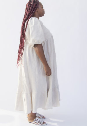 Side view of plus size model wearing Ruffle Midi Dress in Oatmeal Linen.