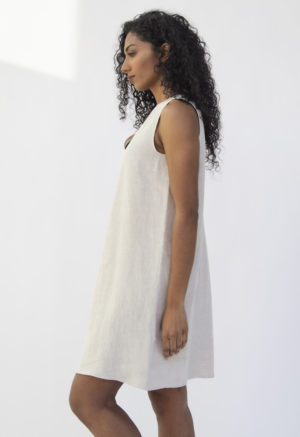 Side view of straight size model wearing Shift Dress in Oatmeal Linen.