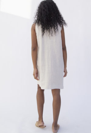 Back view of straight size model wearing Shift Dress in Oatmeal Linen.