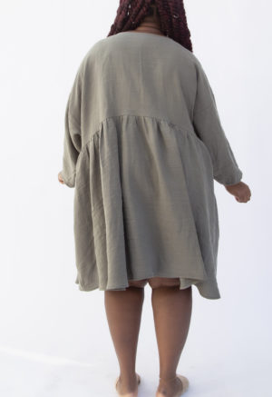 Back view of plus size model wearing Short Oversized Dress in Moss Linen.