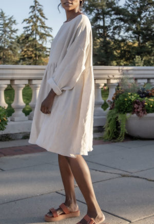 Side view of straight size model wearing Short Oversized Dress in Oatmeal Linen