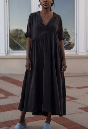 Front view of straight size model wearing Tiered Lapel Dress in Black Linen.